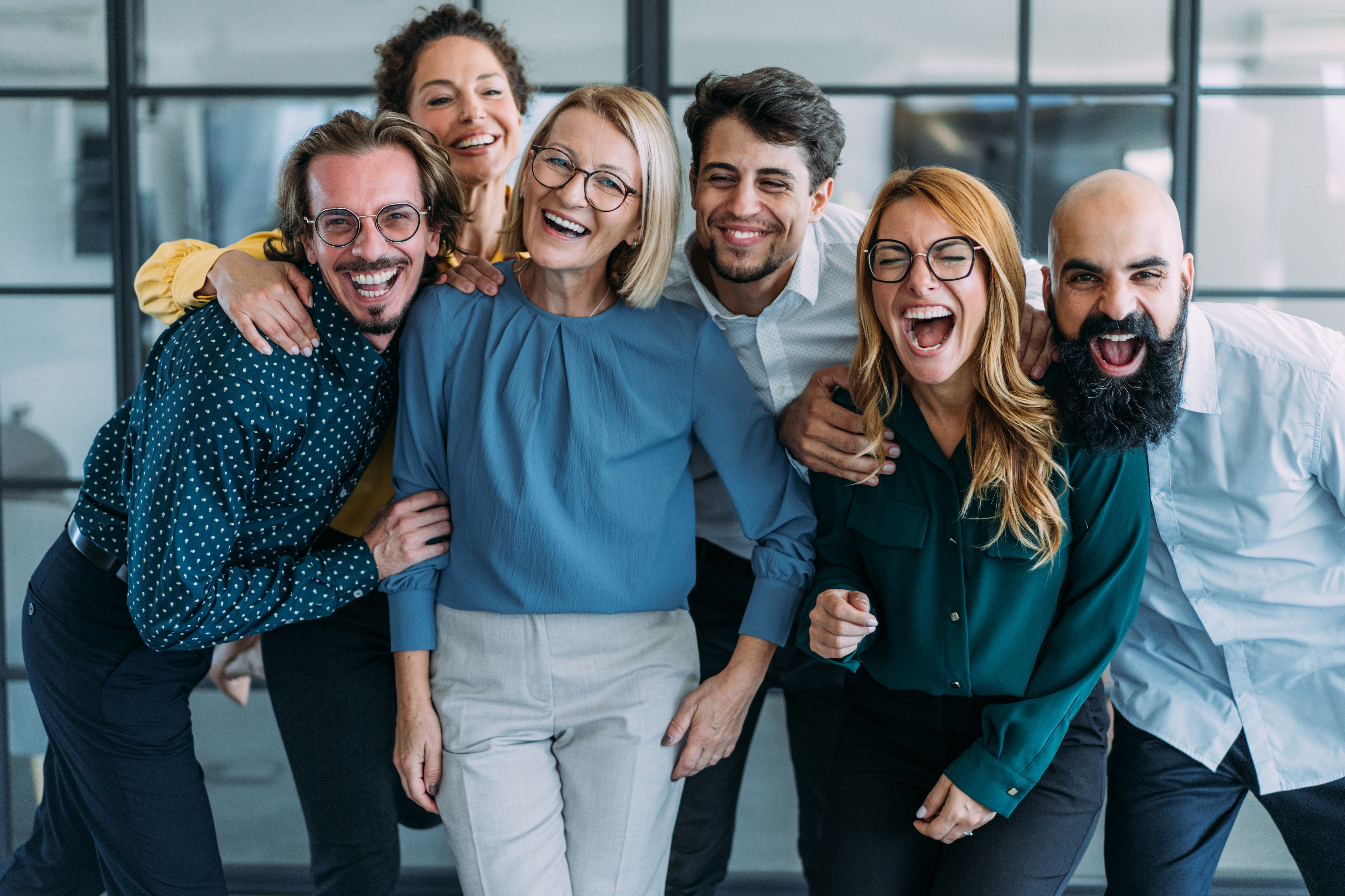 An advice team laughing together in the office.